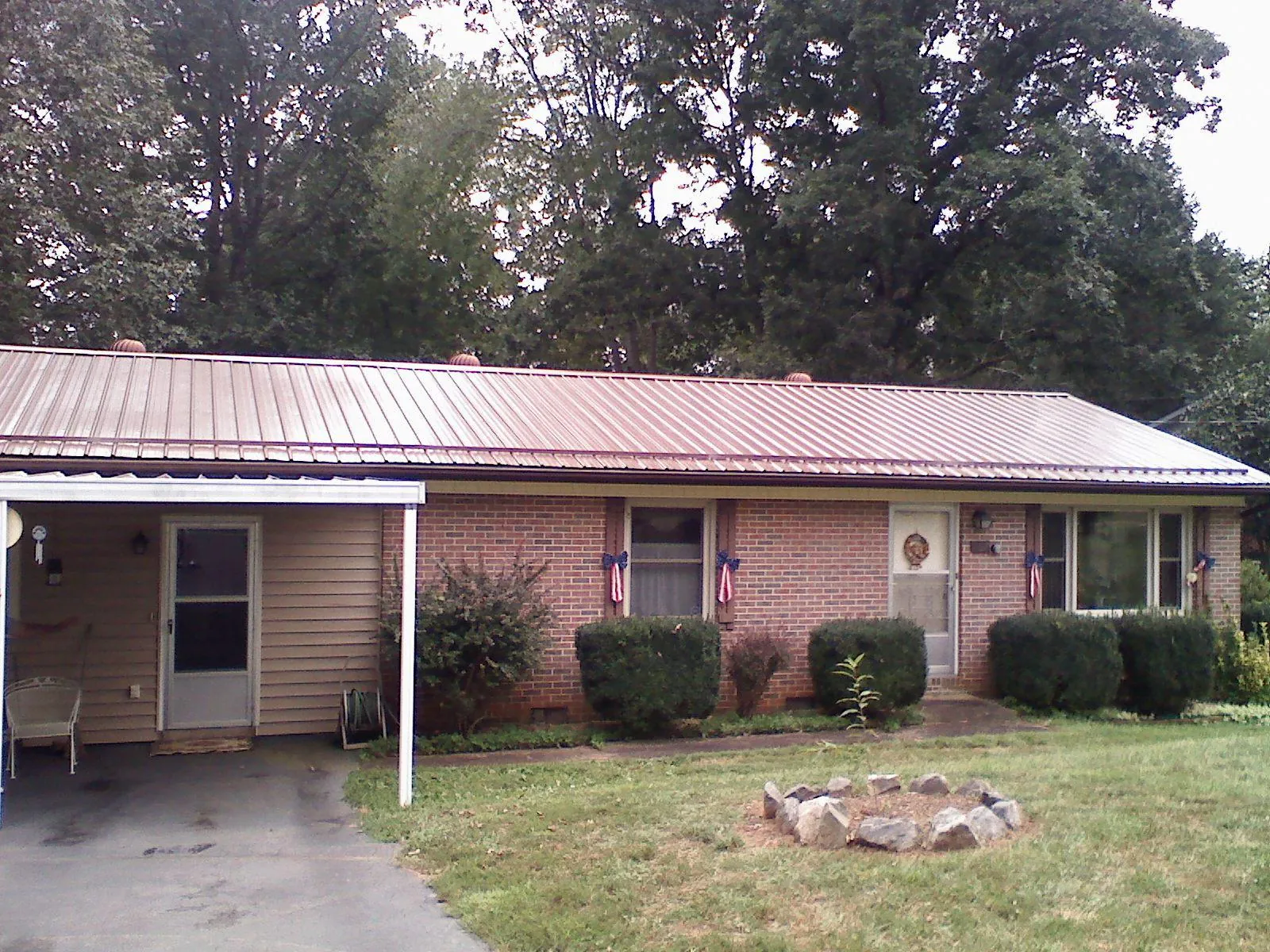 Bronze metal roof and carport on a brick ranch home — Roof Repair work by our crew in Woodside